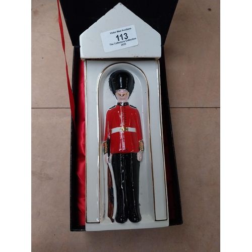 113 - Ceramic bottle in the form of Coldstream Guard. {25 cm H x 9 cm W x 9 cm D}.