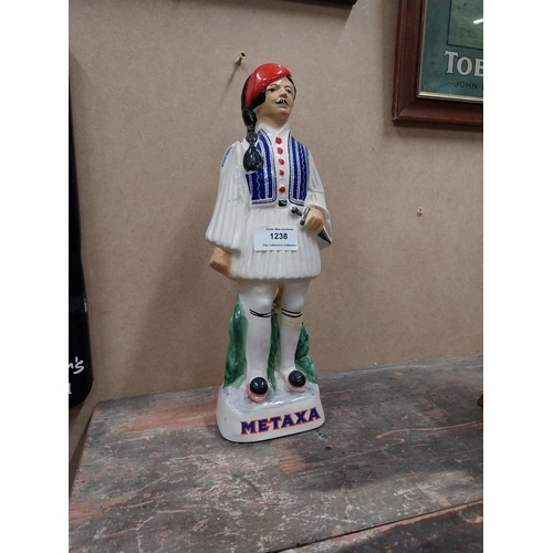 1238 - Metaxa ceramic advertising bottle. {32 cm H x 11 cm W x 8 cm D}.