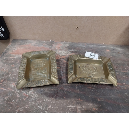 1242 - Two Odgens Guinea Gold brass ashtrays. {2 cm H x 12 cm W x 10 cm D}.