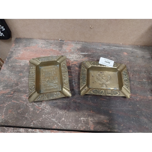 1242 - Two Odgens Guinea Gold brass ashtrays. {2 cm H x 12 cm W x 10 cm D}.