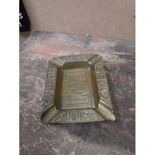 1242 - Two Odgens Guinea Gold brass ashtrays. {2 cm H x 12 cm W x 10 cm D}.