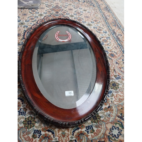 131 - Meux's oval framed advertising mirror. {81 cm H x 51 cm W}.