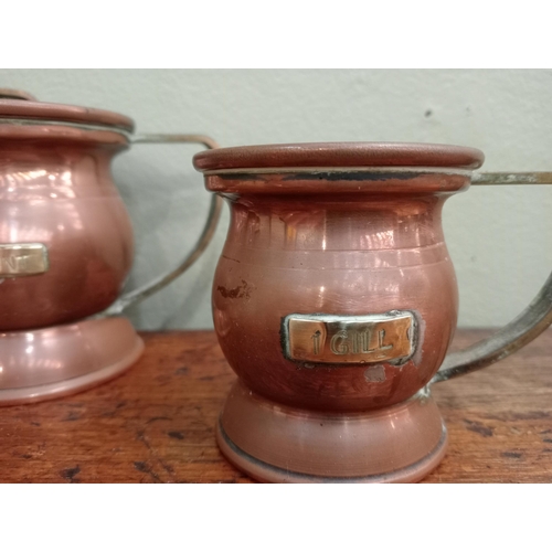 200A - Set of six graduated copper tankards , 1 Quart, 1 pint, 1/2 pint , 1 gill, 1/2 gill, 1/4 gill H 13cm... 