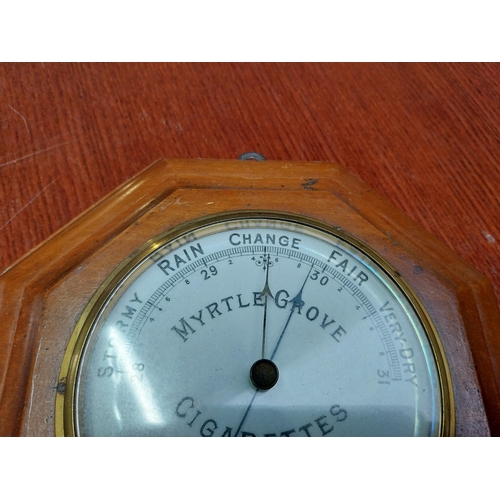 221 - Myrtle Grove Cigarettes mahogany and brass barometer. {24 cm Dia.}.