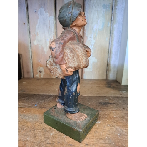 248 - Cast iron newspaper boy advertising figure  H 18cm x W 6cm x D 7cm. NOT AVAILABLE TO VIEW IN PERSON.