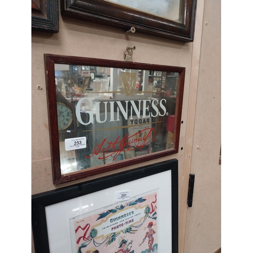 253 - Guinness advertising mirror in wooden frame. {21cm H x 32 cm W}.