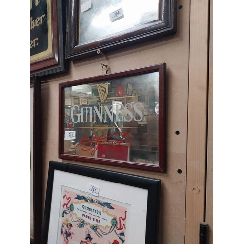 253 - Guinness advertising mirror in wooden frame. {21cm H x 32 cm W}.