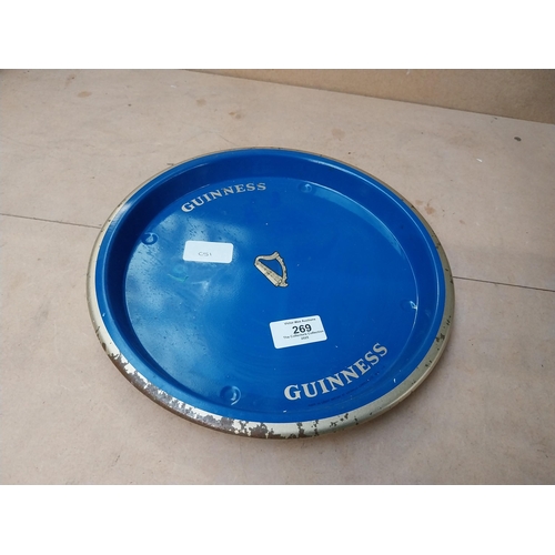 269 - Blue Guinness tin plate drinks tray . {2 cm H x 27 cm Diam.}.