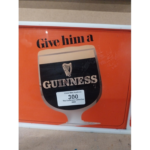 300 - Guinness Give Him a Guinness perspex light up advertising clock. {15 cm H  x 51 cm W x 5 cm D}.