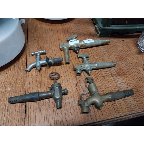 471 - Five 19th C. brass beer taps. {21 cm H x 13 cm W to 11 cm H x 8 cm W}.