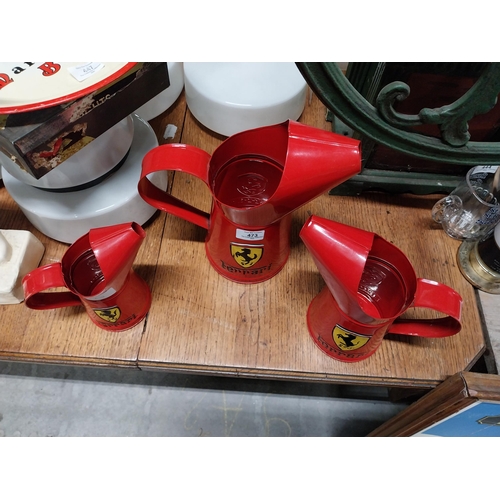 473 - Set of three graduated Ferrari oil measures. {27 cm H x 26 cm W x 15 cm W to 18 cm H x 17 cm W x 10 ... 