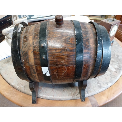 475A - Oak and metal bound barrel on stand. {25 cm H x 26 cm W x 27 cm D}.