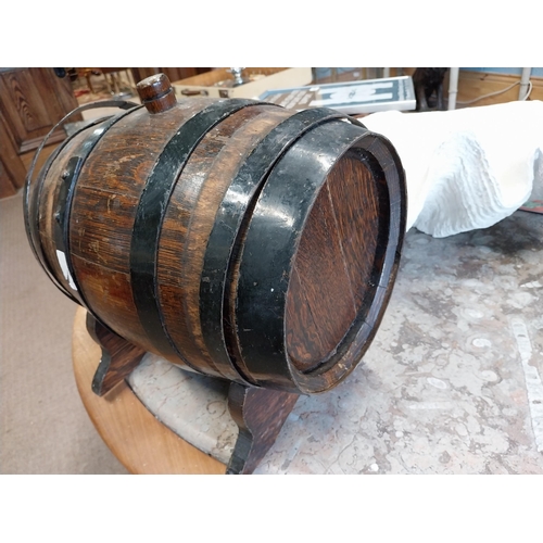 475A - Oak and metal bound barrel on stand. {25 cm H x 26 cm W x 27 cm D}.