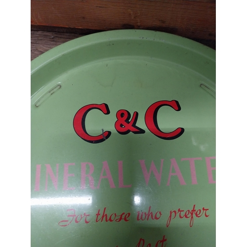 493 - C and C Mineral Waters tin plate drink's tray. {2 cm H x 32 cm Dia.}.