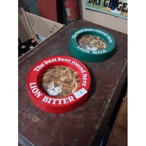 5 - Two plastic Best Beer Round Here Lion Bitter advertising ashtrays. {4 cm H x 21 cm Dia.}.