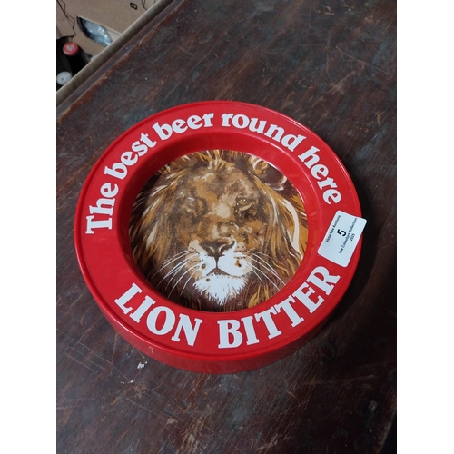 5 - Two plastic Best Beer Round Here Lion Bitter advertising ashtrays. {4 cm H x 21 cm Dia.}.