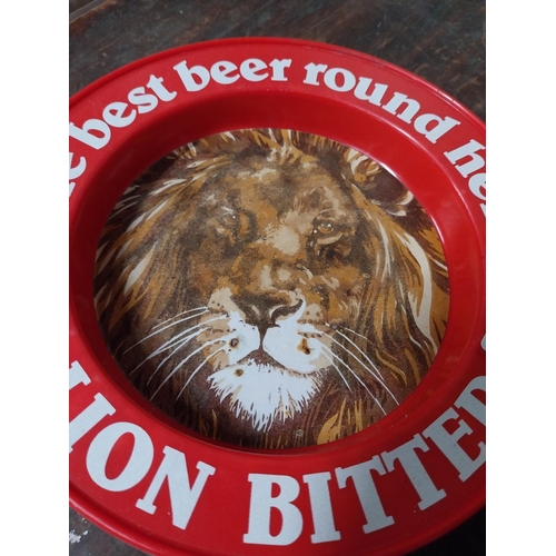 5 - Two plastic Best Beer Round Here Lion Bitter advertising ashtrays. {4 cm H x 21 cm Dia.}.