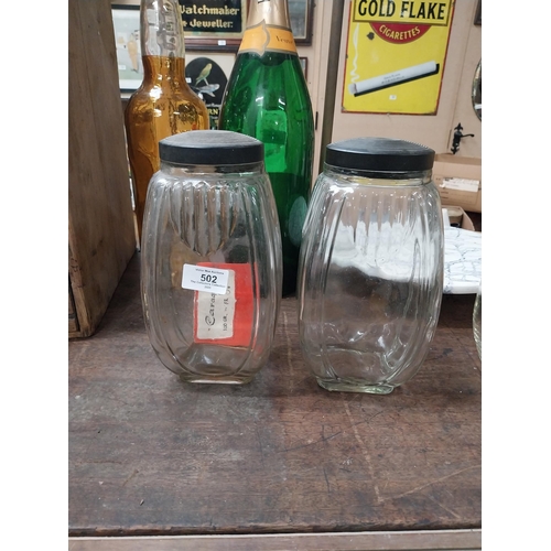 502 - Two 1950's glass sweet jars with bakelite lids. {24 cm H x 12 cm W x 12 cm D}.