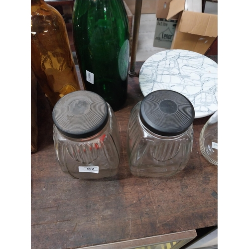 502 - Two 1950's glass sweet jars with bakelite lids. {24 cm H x 12 cm W x 12 cm D}.