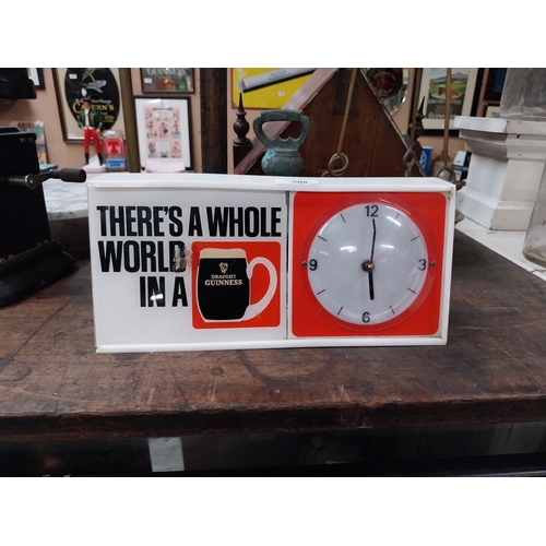 508 - There's a Whole World in a Guinness perspex advertising Clock. {15 cm H x 31 cm W x 7 cm D}.