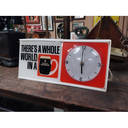 508 - There's a Whole World in a Guinness perspex advertising Clock. {15 cm H x 31 cm W x 7 cm D}.