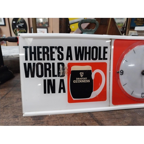 508 - There's a Whole World in a Guinness perspex advertising Clock. {15 cm H x 31 cm W x 7 cm D}.