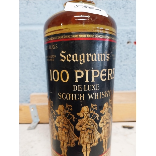 530A - Bottle of Seagram's 100 Pipers Scotch Whiskey. {30 cm H x 7 cm Dia.}.