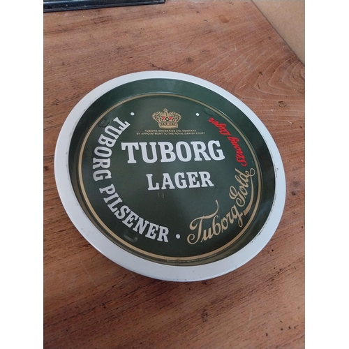 54 - Two Tuborg Lager tin  plate drinks tray. {27 cm Dia}.