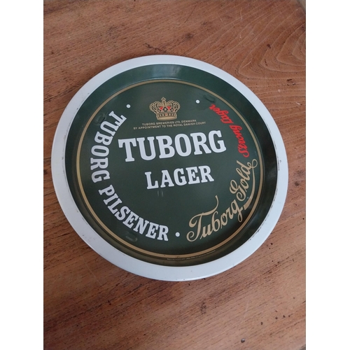 54 - Two Tuborg Lager tin  plate drinks tray. {27 cm Dia}.