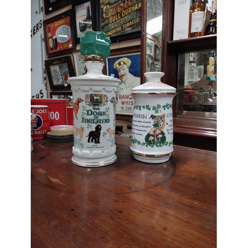 540A - Two ceramic advertising whiskey bottles The Wearing of the Green and The Dogs of Ireland. {2 cm H x ... 