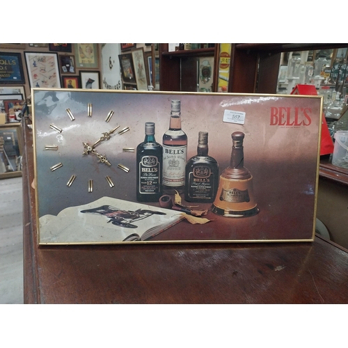 557 - 1970's Bell's Whiskey battery operated advertising wall clock. {27 cm H x 51 cm W}.