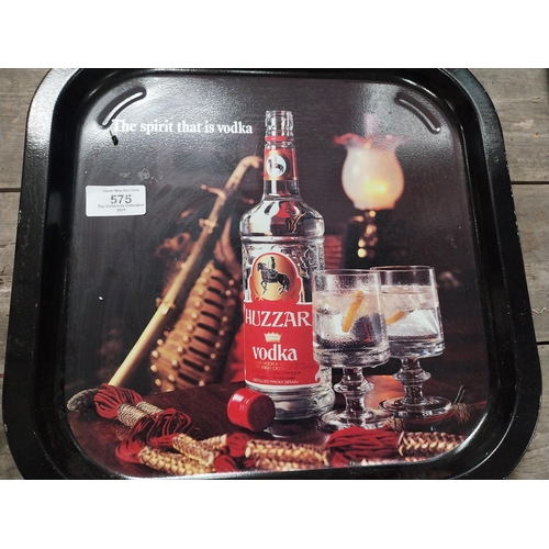 575 - Two tinplate advertising drinks trays - Huzzar Vodka {33 cm H x 33 cm W}.