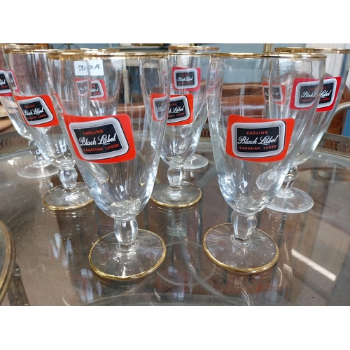 580A - Nine Carling Black Label glasses. {17 cm H x 8 cm W}