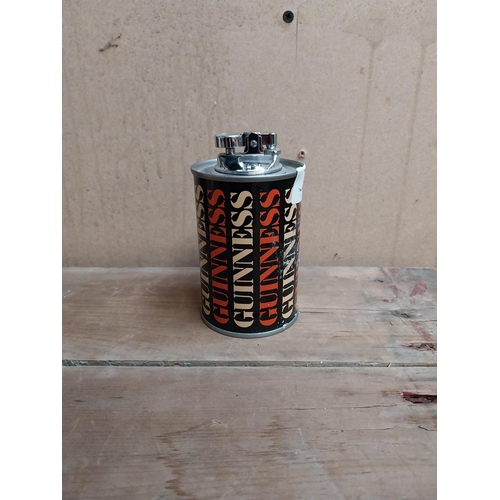 59 - Guinness tin plate Cigarette lighter. {12 cm H x 7 cm Diam.}.