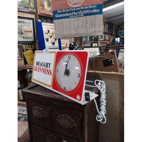 591 - Draught Guinness perspex advertising clock. {15 cm H x 31 cm W}.