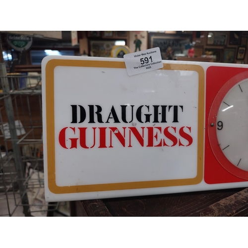 591 - Draught Guinness perspex advertising clock. {15 cm H x 31 cm W}.