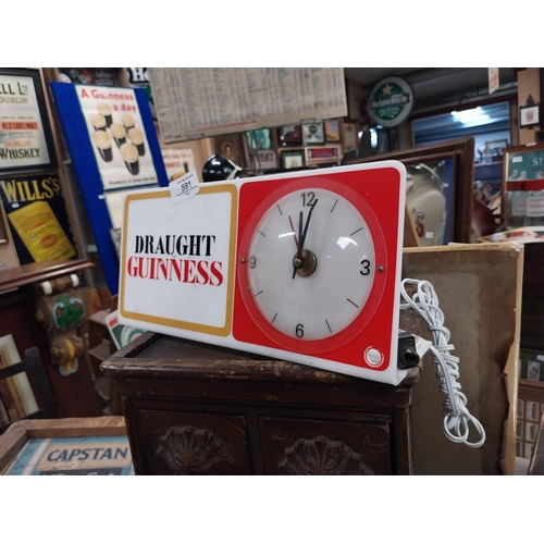 591 - Draught Guinness perspex advertising clock. {15 cm H x 31 cm W}.