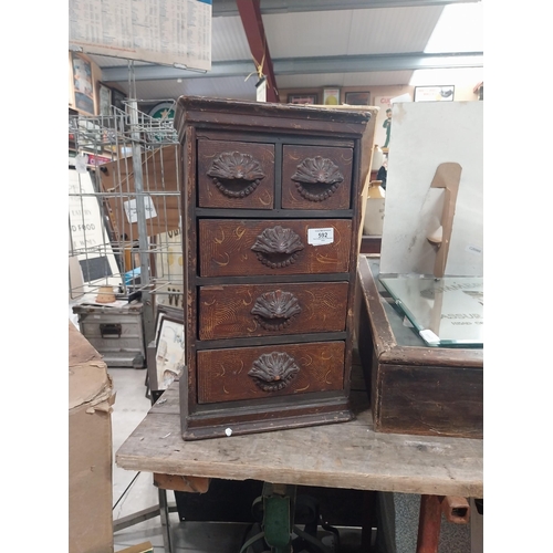 592 - 19th C. scumbled pine shop cabinet with two short drawers over three long drawers with carved wooden... 