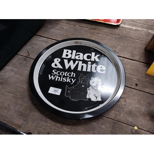 607 - Two Black and White Scotch Whiskey tin plate advertising trays. {2 cm H x 32 cm Dia.}.