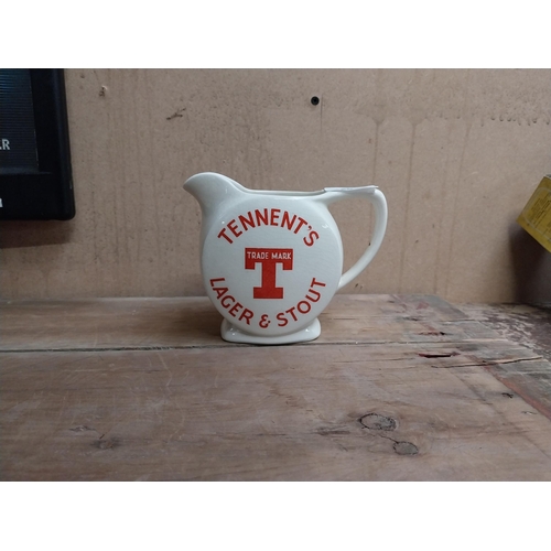 63 - Tennents Lager and Stout ceramic advertising water jug. {12 cm H x 16 cm W x 9 cm D}