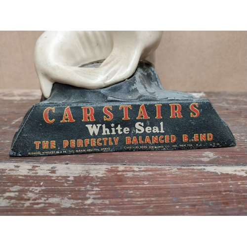 71 - Carstairs White Seal cast alloy advertising figure. {21 cm H x 14 cm W x 12 cm D}.