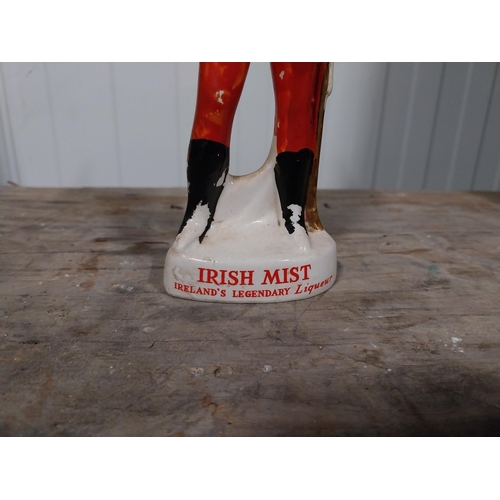 724 - Irish Mist ceramic advertising figure. {27 cm H x 4 cm Dia}.