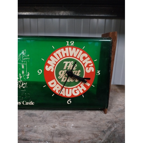 734 - 1970's Smithwick Draught perspex and wood battery operated advertising wall clock. {15 cm H x 34 cm ... 