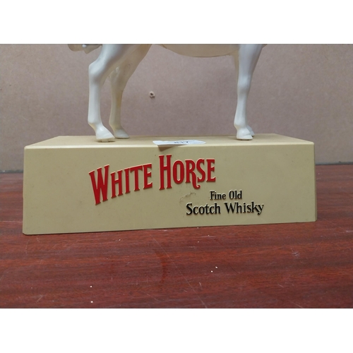White Horse Whiskey plastic advertising figure. {25 cm H x 23 cm W