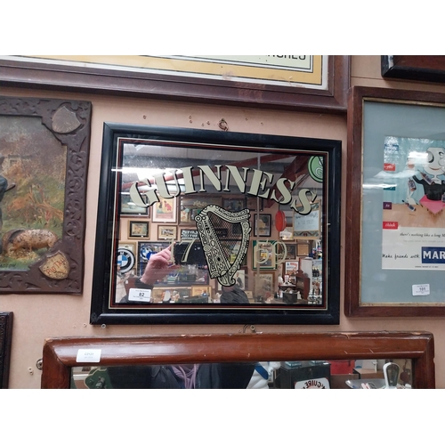 82 - Guinness advertising mirror in wooden frame. {37 cm H x 47 cm W}.