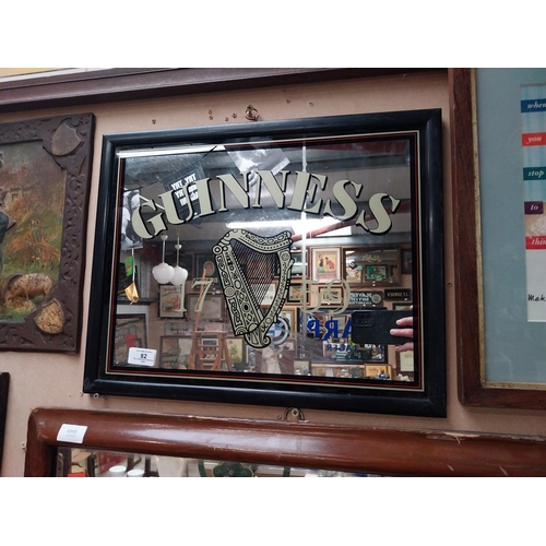 82 - Guinness advertising mirror in wooden frame. {37 cm H x 47 cm W}.