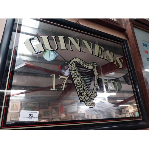 82 - Guinness advertising mirror in wooden frame. {37 cm H x 47 cm W}.