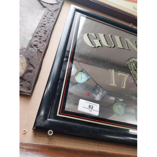 82 - Guinness advertising mirror in wooden frame. {37 cm H x 47 cm W}.