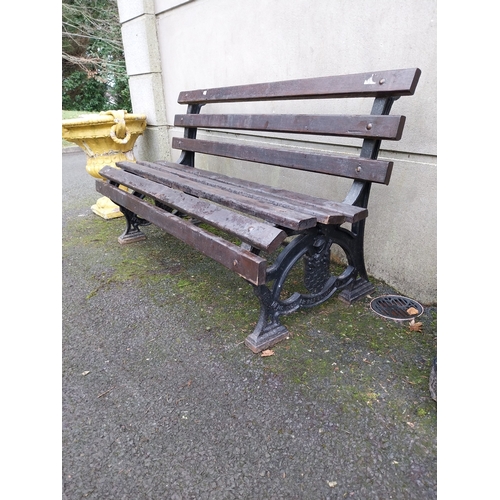 1063 - Early 20th C. Cast iron garden bench with wooden laths. {81 cm H x 153 cm W x 67 cm D}.