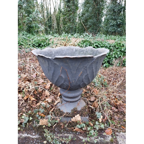 1068 - Pair of cast iron garden urns decorated with acanthus leaves, mounted on stone bases. {33 cm H x 60 ... 